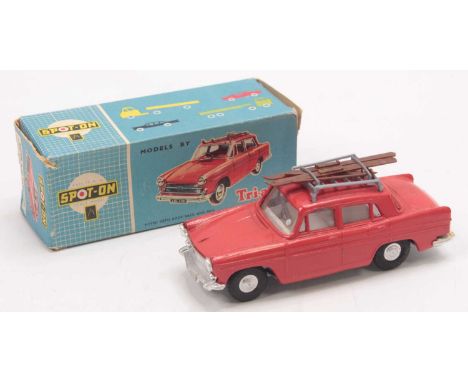 A Triang Spot-On Models No. 184 Austin A60 Cambridge, comprising red body with white interior, spun hubs, and ski and poles l