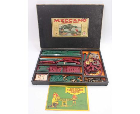 A Meccano No. 5A Outfit comprising of parts in dark red, dark green, nickel and brass, parts include channel segments and gre