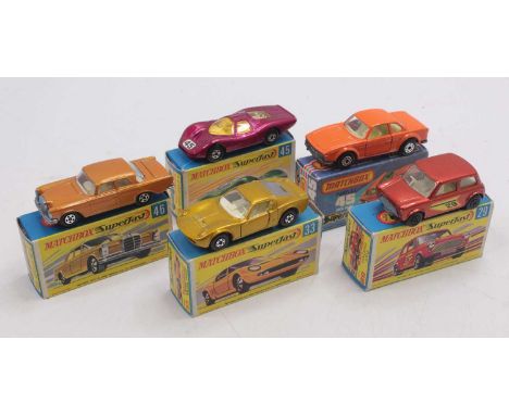 One tray containing five boxed Matchbox Superfast diecast vehicles to include No. 29 Racing Mini, finished in bronze, No. 33 