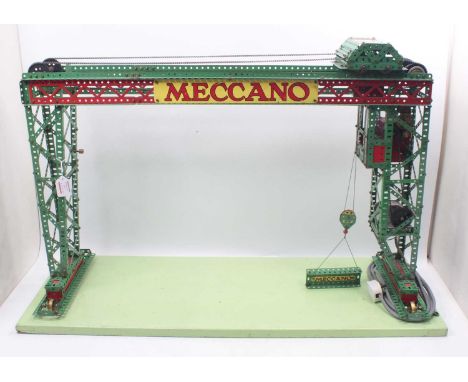 An original 1950s Meccano shop window display model of a gantry crane constructed in red and green components with Meccano si