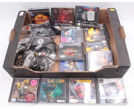 Two trays of Sony Playstation 1 gaming consoles, adapters, memory cards, controllers, and games, to include The Lost World Ju