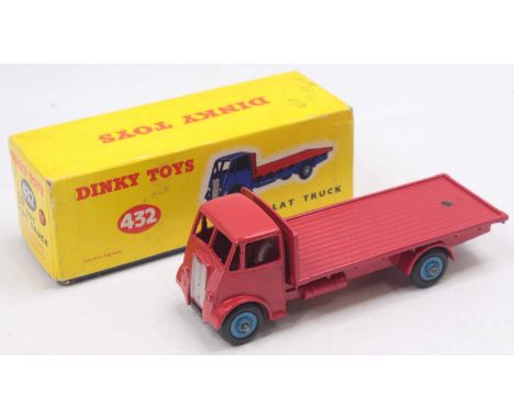 A Dinky Toys No. 432 Guy flat truck comprising of red cab chassis and back with rare blue Supertoys hubs, housed in the origi