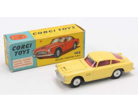 Corgi Toys No. 218 Aston Martin DB4, finished in yellow with red interior and silver hubs, housed in the original blue & yell