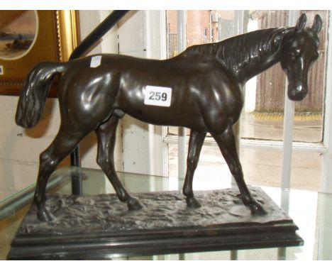 Bronze figure of a thoroughbred horse on plinth