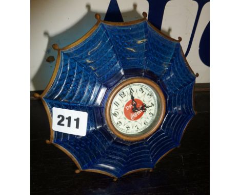Early 20th c. Coca Cola Art Deco advertising clock with blue glass surround in the form of an open umbrella, approx 7" diamet