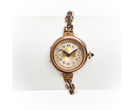 LADY'S EARLY TWENTIETH CENTURY NINE CARAT GOLD WRIST WATCH
the round gilt dial with enamelled Arabic numerals in black within