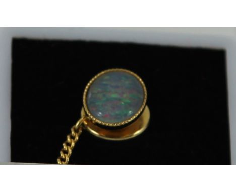 A gilt metal tie pin set with good black opal   