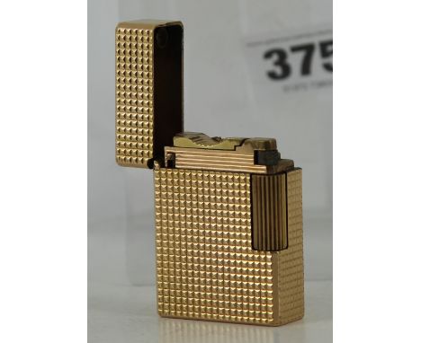 A Dupont gold coloured lighter engine turn decoration  