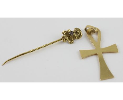 An 18ct. yellow gold pendent in the shape of a Ankh, bail impressed ‘750’ (3.3g), together with a yellow metal stick pin in u