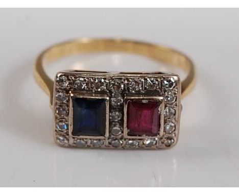 A yellow metal, ruby and sapphire rectangular cluster ring, comprising a step cut ruby and sapphire within a border of 23 sin