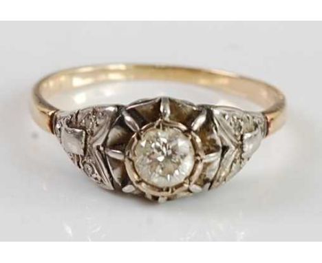 An early 20th century yellow metal diamond solitaire ring, the illusion set old round cut diamond weighing approx 0.4 carats,