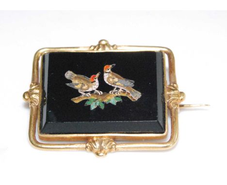 A late 19th century yellow metal micro-mosaic brooch, the brooch depicting two woodpeckers on a branch with black background,