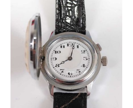 A stainless steel manual wind novelty wristwatch, having a hinged golf ball cover and a round white Arabic dial, fitted to a 