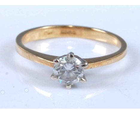 An 18ct yellow and white gold diamond single stone ring, featuring a round brilliant cut diamond in a six-claw setting, diamo