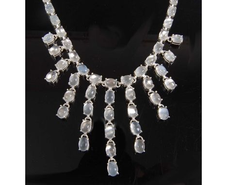 A white metal moonstone fringe necklet, comprising 70 oval moonstone cabochons in claw settings, with adjustable chain and lo