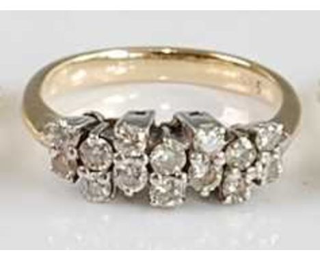 A yellow metal diamond half hoop ring, arranged as seven pairs of small brilliant cut diamonds, each being four claw set, tot