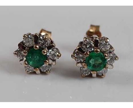 A pair of 9ct yellow and white gold emerald and diamond circular cluster earrings, each with a centre round faceted emerald w