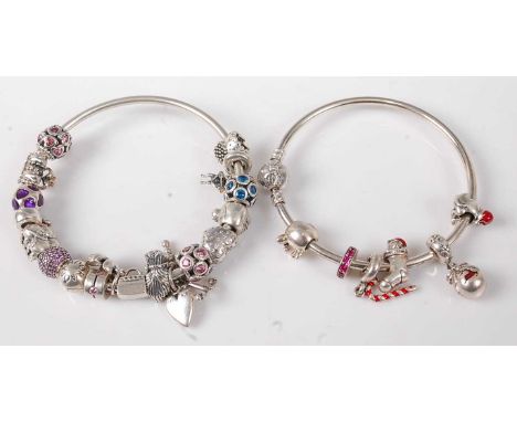 A Pandora silver bangle containing a collection of various Pandora silver and paste set charms; together with an Ale silver b