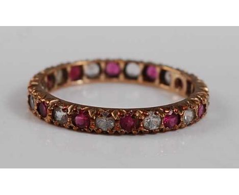 A 9ct yellow gold, synthetic ruby and sapphire full hoop eternity ring, featuring 13 round faceted rubies alternating with sy