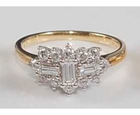 An 18ct yellow and white gold diamond oblong cluster ring, comprising three centre baguette cut diamonds within a border of t