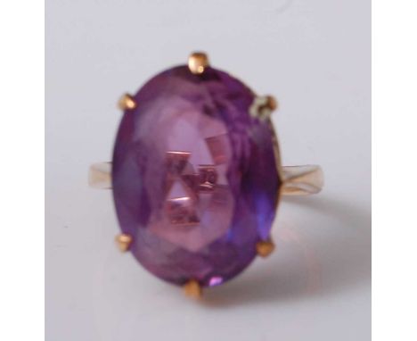 A 9ct yellow gold and synthetic purple sapphire ring, the oval synthetic sapphire in a six-claw setting, dimensions approx 16