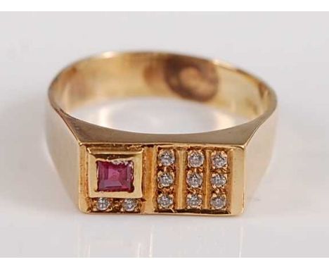 A yellow metal rectangular signet ring, the head set with one rectangular cut ruby and 11 round faceted colourless sapphires,