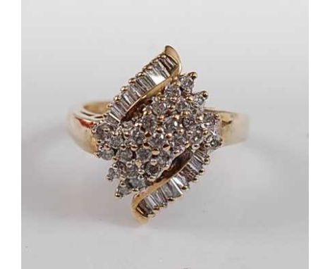 A 9ct yellow gold diamond marquise shaped cluster ring, featuring twenty-five round brilliant cut diamonds within two rows of