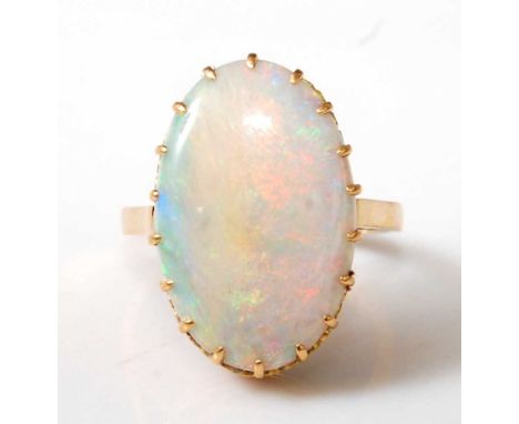 An 18ct yellow gold oval opal dress ring, the cabochon cut opal measuring approx 20.2 x 13.0 x 3.1mm, total weight estimated 