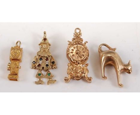 Four assorted 9ct yellow gold charms, comprising: an engraved carriage clock with moveable hands, 29 x 15mm, hallmarked 9ct, 