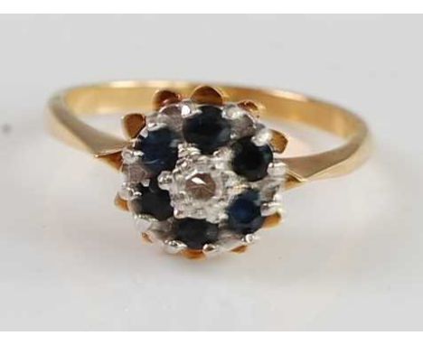 An 18ct gold, blue and white sapphire flower head cluster ring, arranged as two tiers with small round cut stones, 3g, size K