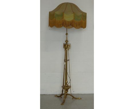 A stylish Arts and Crafts style gilt metal floor standing Lamp Standard, the oversize two tone lamp shade above vertical supp