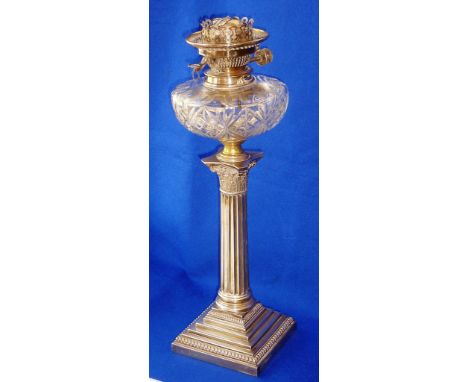 A large early 20th Century Oil Lamp, the cut glass clear reservoir above a hallmarked silver presentation stand modelled as a