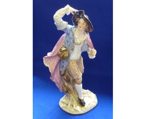 A 19th Century Meissen porcelain Figure of a young gentleman with flowing red/pink cloak and large upturned hat, the male Fig