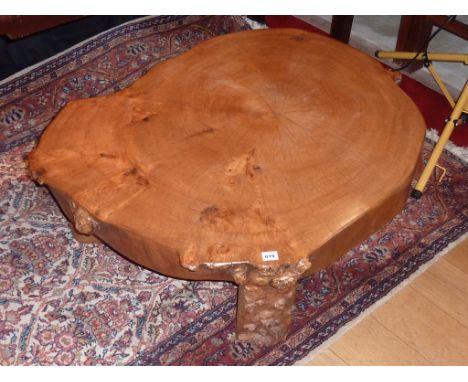 A rustic tree trunk sectional Occasional Table of good colour (probably yew wood) upon three supporting legs with gnarled bar