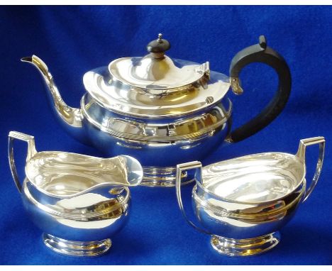 A heavy hallmarked silver three piece Tea Service comprising Tea Pot , Cream Jug and two handled Sugar, each on spreading ova