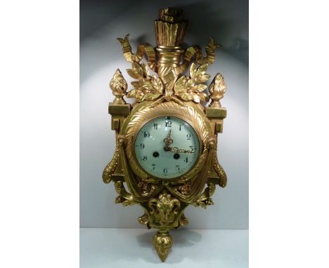 A good 19th Century gilt metal French Cartel Clock with central quiver amongst laurel style leaves and swags etc., further fl