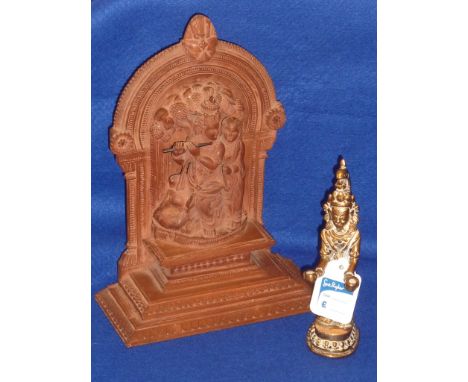 An early 20th Century Eastern style softwood Carving, crowned man playing a flute within an arched alcove with female attenda