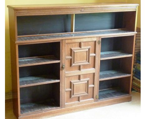 A late 19th Century aesthetic movement walnut open Bookcase, the moulded top above inverted tear drop style incised frieze an