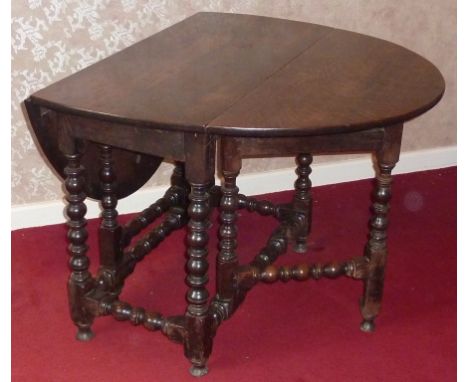 A late 17th Century style oval topped oak gate-leg Table on bobbin turned supports with similar stretchers, 130cm (leaves up)