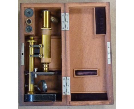 A mahogany cased student's style Microscope with extra accessories including Glass Plates and various sized eye-pieces etc., 