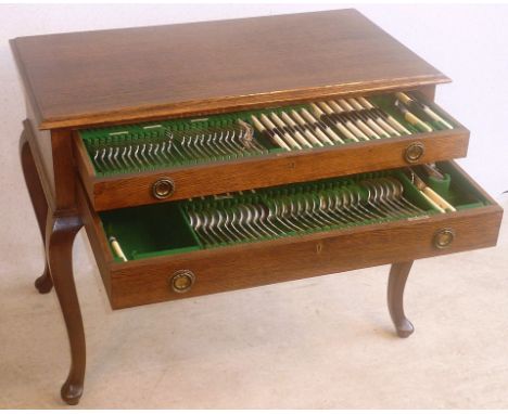 A fine early 20th Century oak silver Cutlery/Flatware Table, the thumbnail moulded top above two full width drawers containin