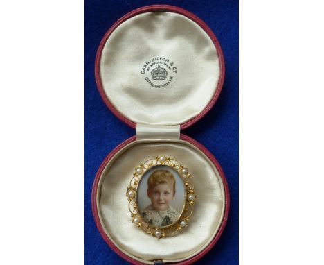 A cased late 19th/early 20th Century yellow metal (marked 15ct) oval Brooch, the finely painted portrait vignette on ivory of