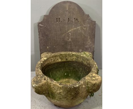 MORTAR SHAPE STONE PLANTER and a shaped top slab of slate, 26cms H, 53cms across and 64cms H x 47cms across, measurements res