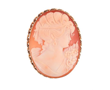 
	
		A MID 20TH CENTURY SHELL CAMEO BROOCH 
		BIRMINGHAM 1959
		The oval panel carved with the profile of a lady with scarf t