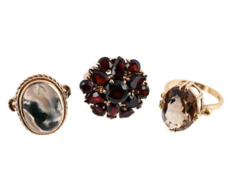 
	
		THREE VINTAGE DRESS RINGS 
		The first an 18 carat gold set oval cut smoky quartz set dress ring, London 1961, maker&#39