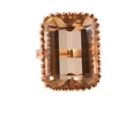 
	
		A 1960S CITRINE DRESS RING 
		The step cut citrine within triangular shaped claws with beaded connectors between, to rop