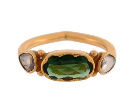 
	
		A GREEN TOURMALINE AND DIAMOND DRESS RING 
		The oval cut green tourmaline between polki diamond shoulders, with bead de