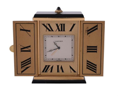 
	
		MUST DE CARTIER
		A GILT METAL AND ONYX TRIPTYCH DESK ALARM CLOCK, NO. 01368, CIRCA 1988
		Movement: Quartz alarm
		Case