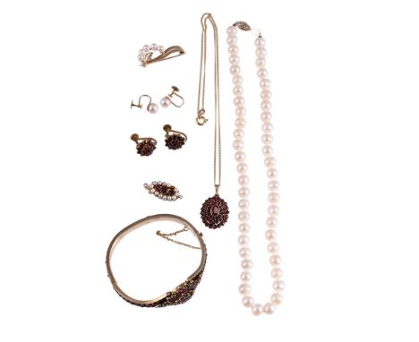 
	
		A COLLECTION OF JEWELLERY 
		To include an early 20th century Bohemian garnet hinged bangle, the gilt settings with part