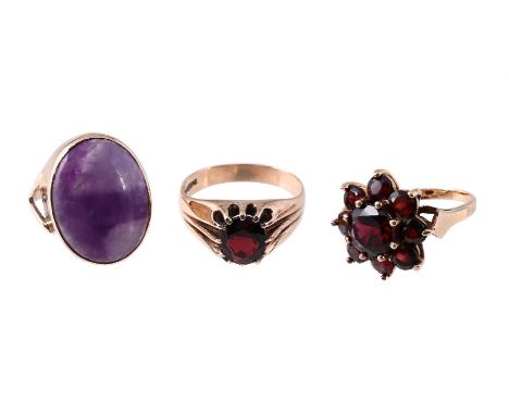 
	
		A GARNET RING, A GARNET CLUSTER RING AND A BLUE JOHN DRESS RING 
		The first a garnet cluster ring, with rubbed partial 